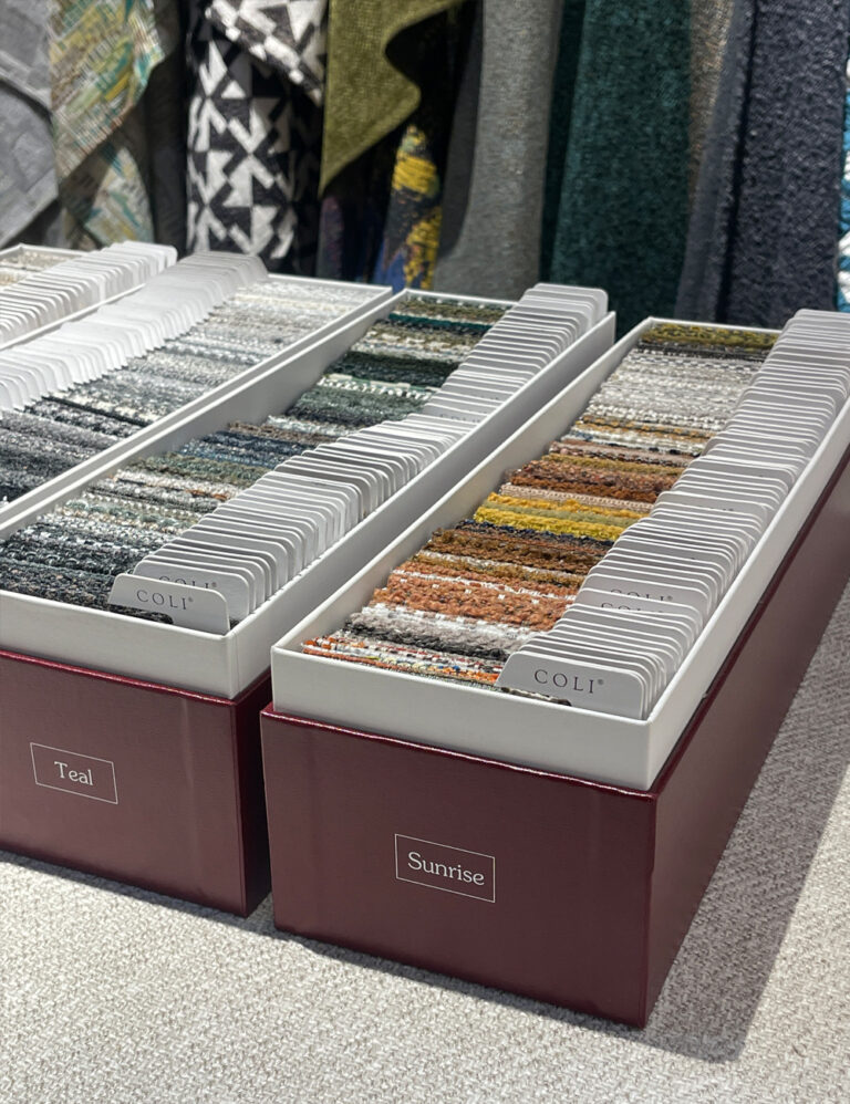 Curtain and upholstery fabric sample sets organized in display boxes